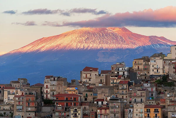 Centuripe historic center with the mount Etna (volcano) covered with snow at sunset, Centuripe, Enna province, Sicily, Italy