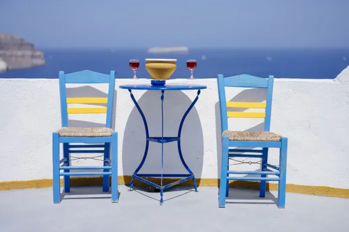 Framed Print : Chairs and table with two glasses of red wine against sea, Santorini, Cyclades Framed Print : Chairs and table with two glasses of red wine against sea, Santorini, Cyclades