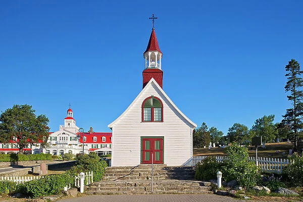 Chapelle de Tadoussac - the oldest wooden church in North America, built in 1747 - with Hotel in the background Tadoussac, Quebec, Canada