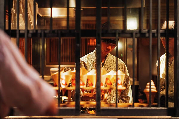 Chef preparing takoyaki famous street food in Osaka, Japan