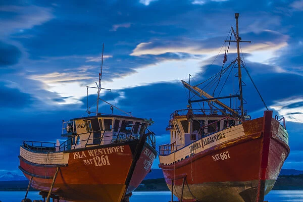 Chile, Magallanes Region, Puerto Natales, Seno Ultima Esperanza bay, fishing boats, dusk