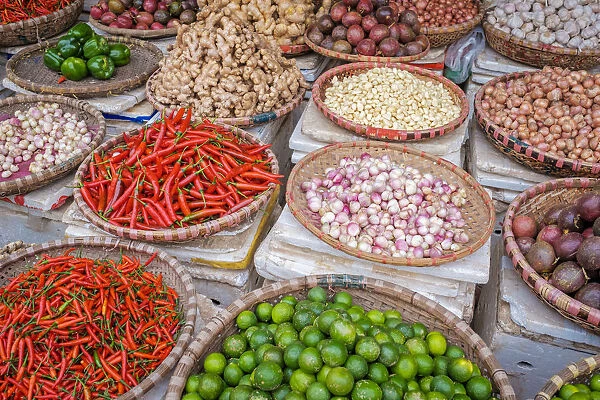 Chili peppers, limes, ginger and garlic for sale at Dong Xuan Market, Hoan Kiem District