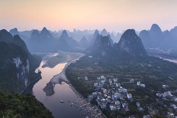 China, Guanxi, Yangshuo. Sunset over Li river and karst peaks, elevated view