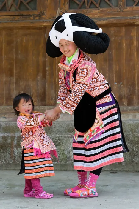 Framed Print : China, Zhonghua, Guizhou, Long-horned Miao woman playing with her daughter Framed Print : China, Zhonghua, Guizhou, Long-horned Miao woman playing with her daughter