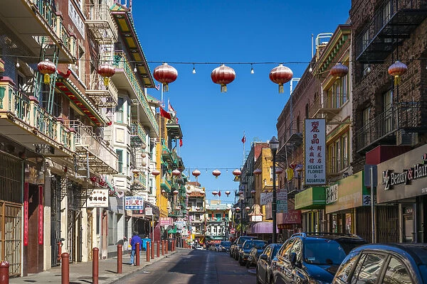 Chinese lanterns hanging over street amidst buildings in Chinatown, San Francisco