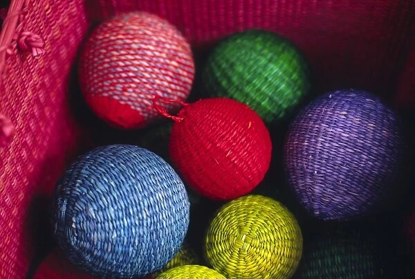 Christmas decorations woven from straw fibre are colourful
