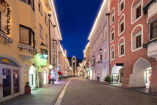 Christmas lights on colorful houses of the old town and Torre delle Dodici medieval tower