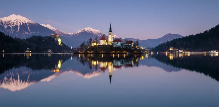 Framed Print : Church of the Assumption of the Blessed Virgin Mary, on Bled island, Lake Bled, at dusk in winter, with the Julian Alps in the distance, Bled, Slovenia