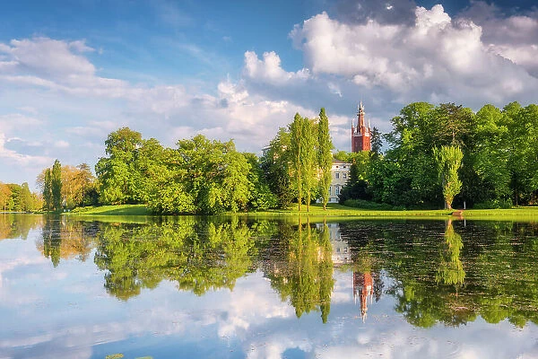 Church, castle and deciduous trees reflected in the lake Worlitz, Dessau-Worlitzer Garden Realm, English style landscape park, Unesco World Heritage site, Dessau-Worlitz, Saxony-Anhalt, Germany