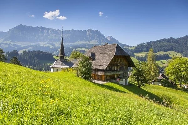 Church and farmhouse in a village in the Emmental Valley, Berner Oberland, Switzerland