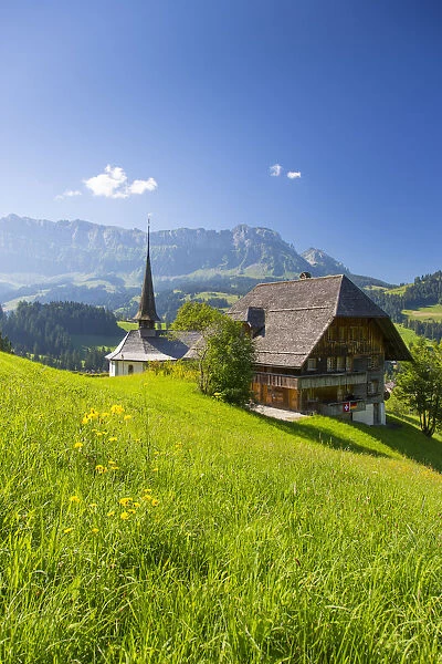 Church and farmhouse in a village in the Emmental Valley, Berner Oberland, Switzerland