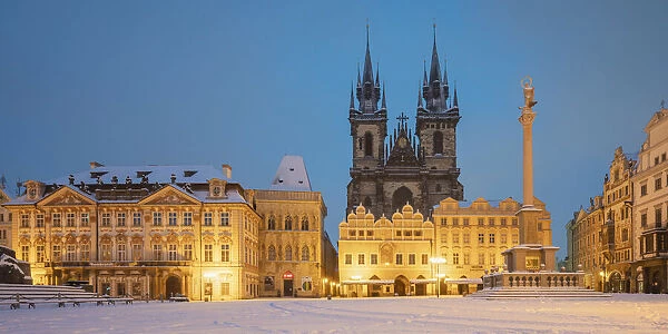 Church of our lady before Tyn at snow-covered Old Town Square at twilight in winter