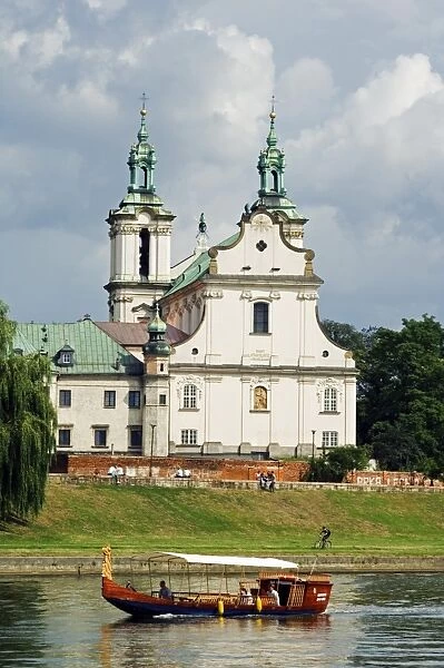 Church overlooking Boat on Vistula River, Krakow, Poland