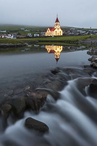 Church and river of Sandavagur at dusk, Vagar island, Faroe Islands, Denmark, Europe