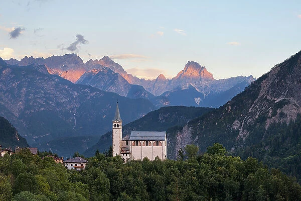 The church of San Martino with Cima dei Preti - Duranno group on the background at sunset, Dolomites, Valle di Cadore, Belluno province, Veneto, Italy