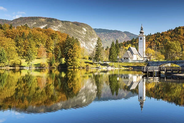 Church of St. John the Baptist reflecting in Lake Bohinj, Slovenia, Europe