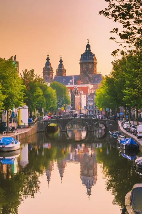 Framed Print : Church of St Nicholas reflecting in the canal at sunrise on a summer evening in Amsterdam Framed Print : Church of St Nicholas reflecting in the canal at sunrise on a summer evening in Amsterdam