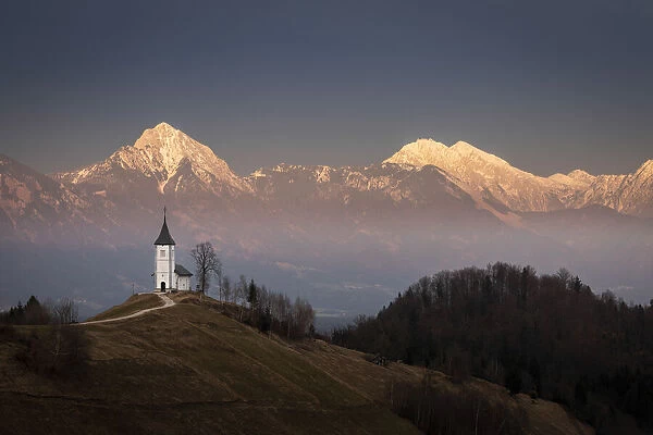 Church of St. Primoz and Storzic Mountain at sunset, Jamnik, Slovenia