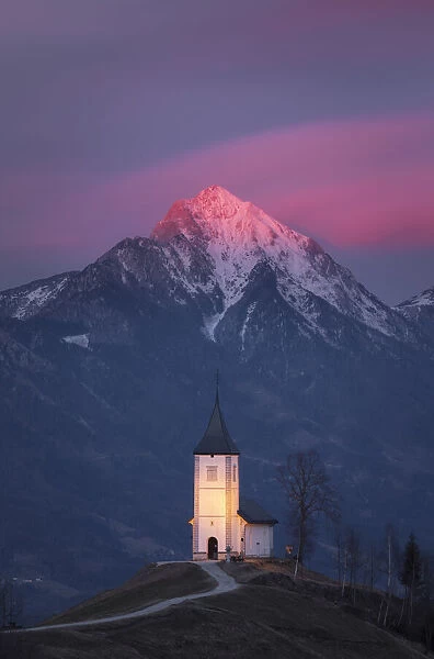 Church of St. Primoz and Storzic Mountain at sunset, Slovenia