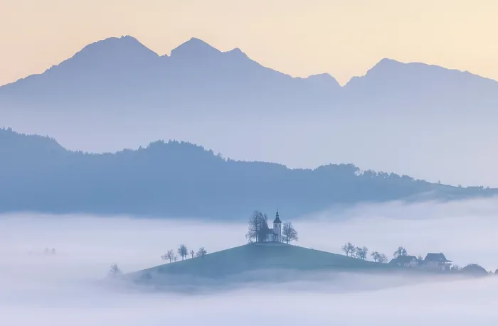 Framed Print : Church of St. Thomas and the Kamink Savinja Alps at sunrise, in autumn, Skofja Loka, Slovenia