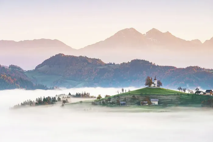Framed Print : Church of St. Thomas and the Kamink Savinja Alps in winter, Skofja Loka, Slovenia