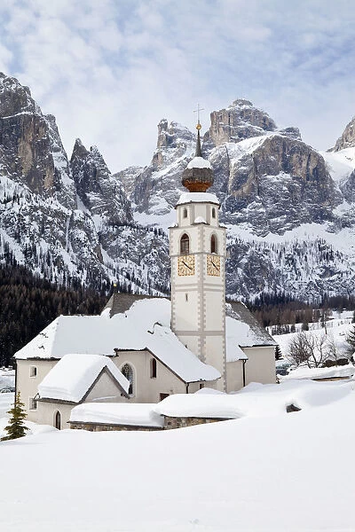 The church and village of Colfosco in Badia (1645m) and Sella Massif range of Mountains
