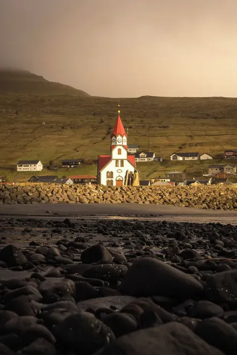 Framed Print : The church in the village of Sandavagur at sunset. Island of Vagar. Faroe Islands
