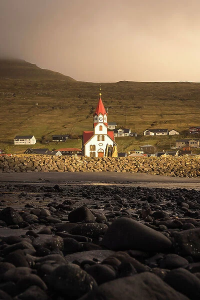 The church in the village of Sandavagur at sunset. Island of Vagar. Faroe Islands