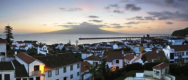 The city of Horta at dawn with the volcano of Pico island on the horizon