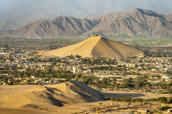 Framed Print : City of Ica viewed from dune at Huacachina against mountains, Ica Region, Peru Framed Print : City of Ica viewed from dune at Huacachina against mountains, Ica Region, Peru