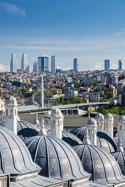 City skyline from Suleymaniye mosque complex with Golden Horn metro bridge and modern