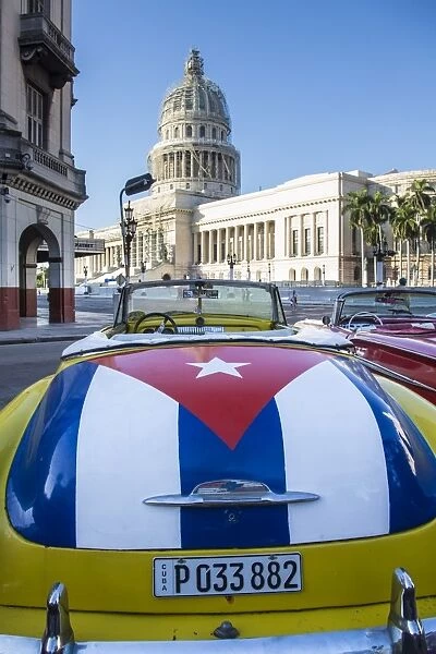 Classic American car with the Cuban flag painted in its boot, Parque Central, Havana