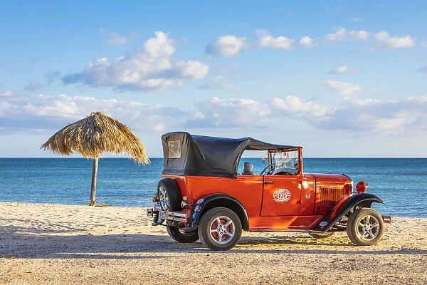 A classic car on a beach in Playa Ancoa, in Trinidad, Sancti Spiritus, Cuba