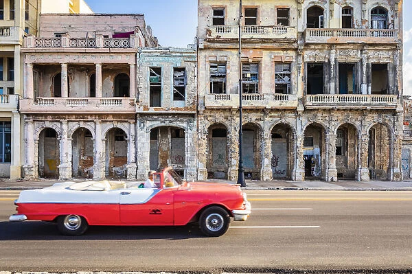 A classic car driving on the Malecon, La Habana Vieja (Old Town), Havana, Cuba