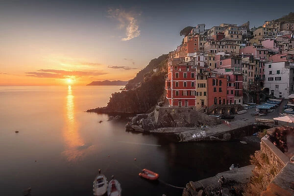 A clear sky over the town of Riomaggiore, part of the Cinque Terre in Italy, during a spring sunset. Cinque Terre, Italy