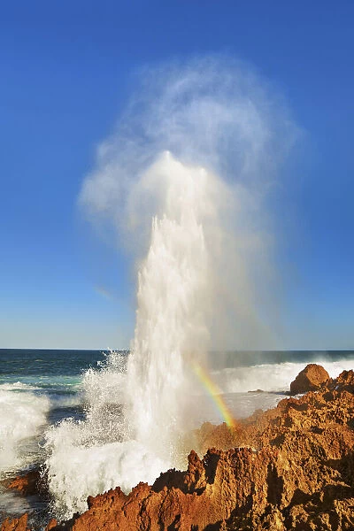 Cliff landscape with blowhole and rainbow at Point Quobba - Australia, Western Australia