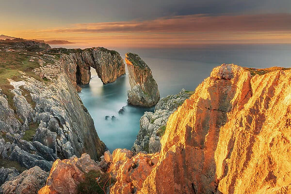 Cliff landscape with rock needle and rock arch called Pena Flecha- Spain, Asturias, Oriente, Ribadesella, Bufones de Pria - Bay of Biscay, Costa Verde