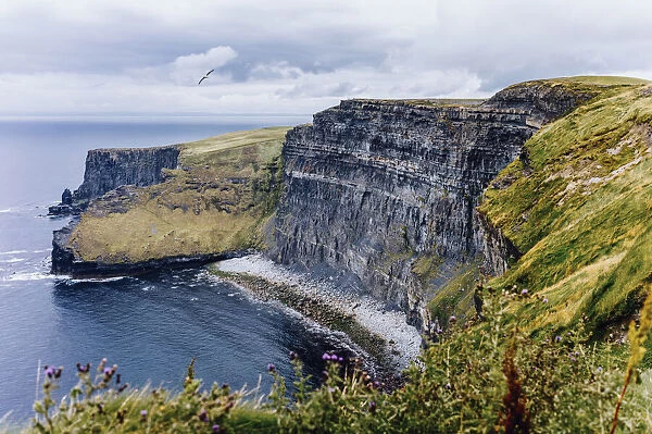 Cliffs of Moher, County Clare, Munster province, Republic of Ireland. Typical irish mood, clouds and blue sky