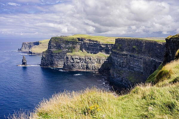 Cliffs of Moher, County Clare, Munster province, Republic of Ireland. Typical irish mood, clouds and blue sky