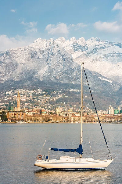 Close up of a boat on Lecco lake with Lecco city and Resegone mount in the background