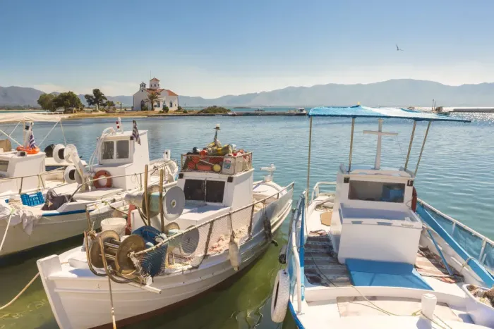 Framed Print : Close up of fishing boats at Elafonissos harbour and church of St Framed Print : Close up of fishing boats at Elafonissos harbour and church of St