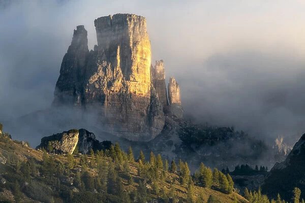 A close-up view of the Cinque Torri from the Giau Pass, taken during a foggy late summer morning. Dolomites, Italy