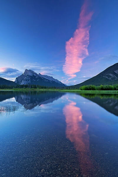 Cloud at dawn reflected in Vermillion Lakes with Mtount Rundle and Sulphur Mountain. Banff National Park, Alberta, Canada