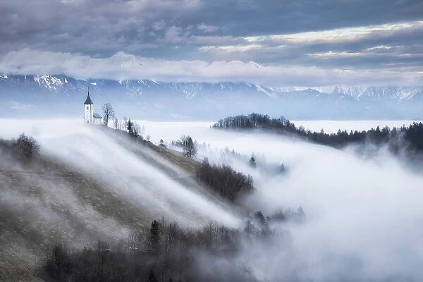 Cloud inversion around Church of St. Primoz, Jamnik, Slovenia