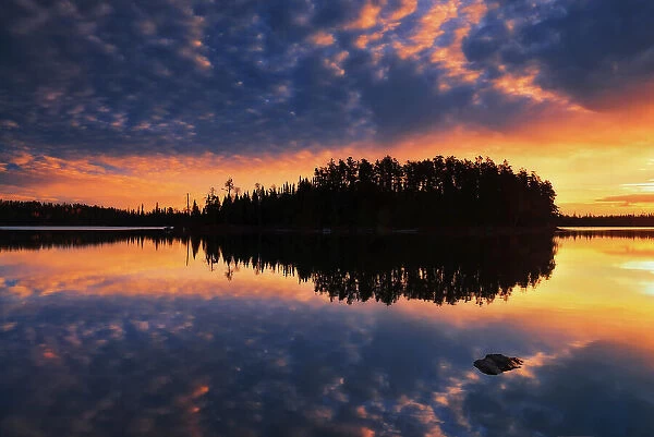 CLouds reflected on Fungus Lake at sunrise West of Wawa, Ontario, Canada