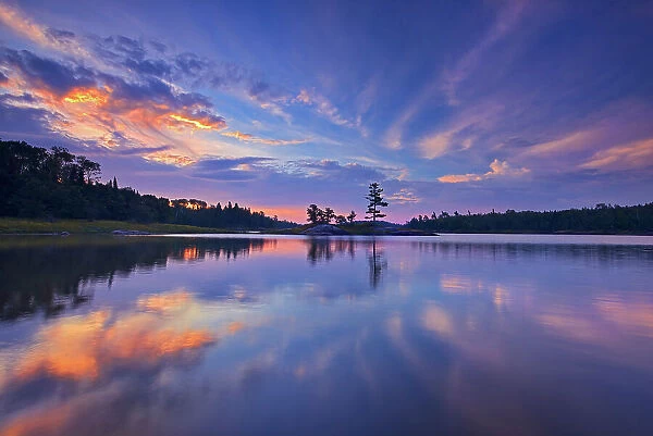 Clouds reflected in Middle Lake at sunrise Kenora, Ontario, Canada