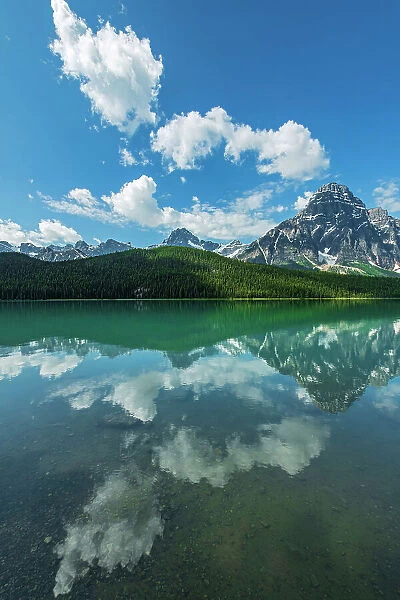 Clouds reflected in Upper Waterfowl Lake with Mt. Chephren right of centre and Howse Peak (left of centre), Banff National Park, Alberta, Canada