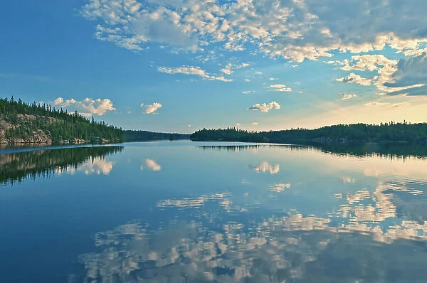 Clouds reflected in White Lake Flin Flon, Manitoba, Canada