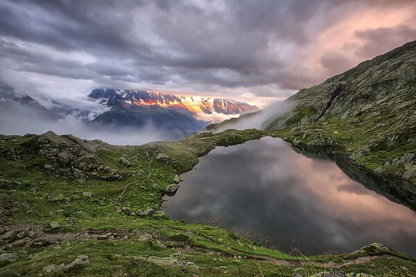 Clouds are tinged with purple at sunset at Lac de Cheserys Chamonix Haute Savoie