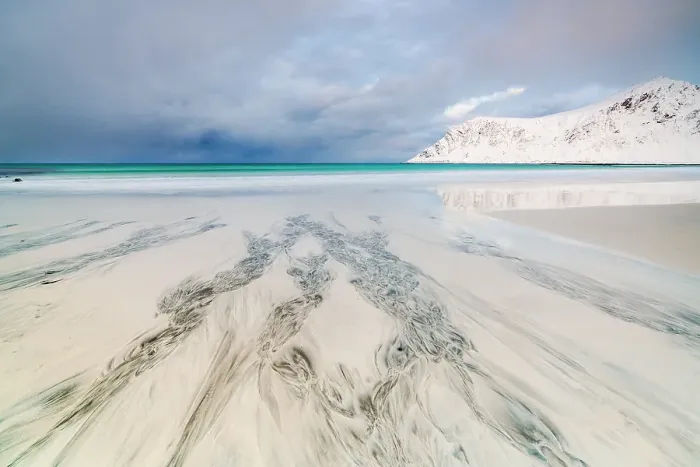 Framed Print : Cloudy sky over the frozen sand of Skagsanden beach, Flakstad, Lofoten Islands, Nordland, Norway